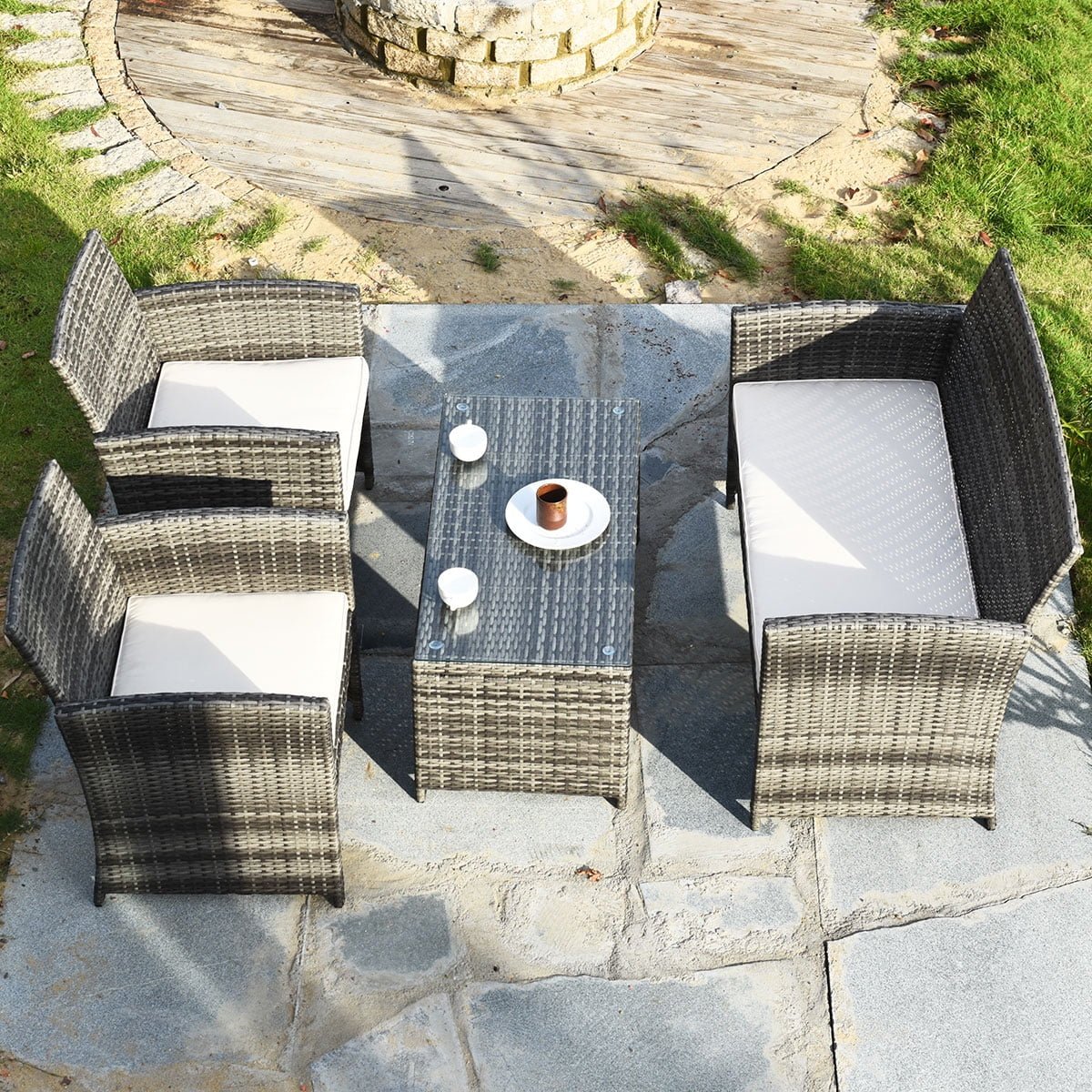 Luxurious 4 - Piece Rattan Patio Set: Beige Cushioned Sofa & Glass Table for Outdoor Oasis - Shop Now - Nourishment Tapestry